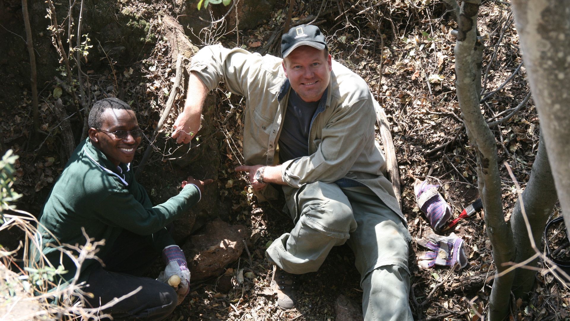 Lee Berger and Job Kibii moments after Berger discovered Malapa Hominin 2, the adult female Paratype of Australopithecus sediba. Photo courtesy Lee Berger and the University of the Witwatersrand.