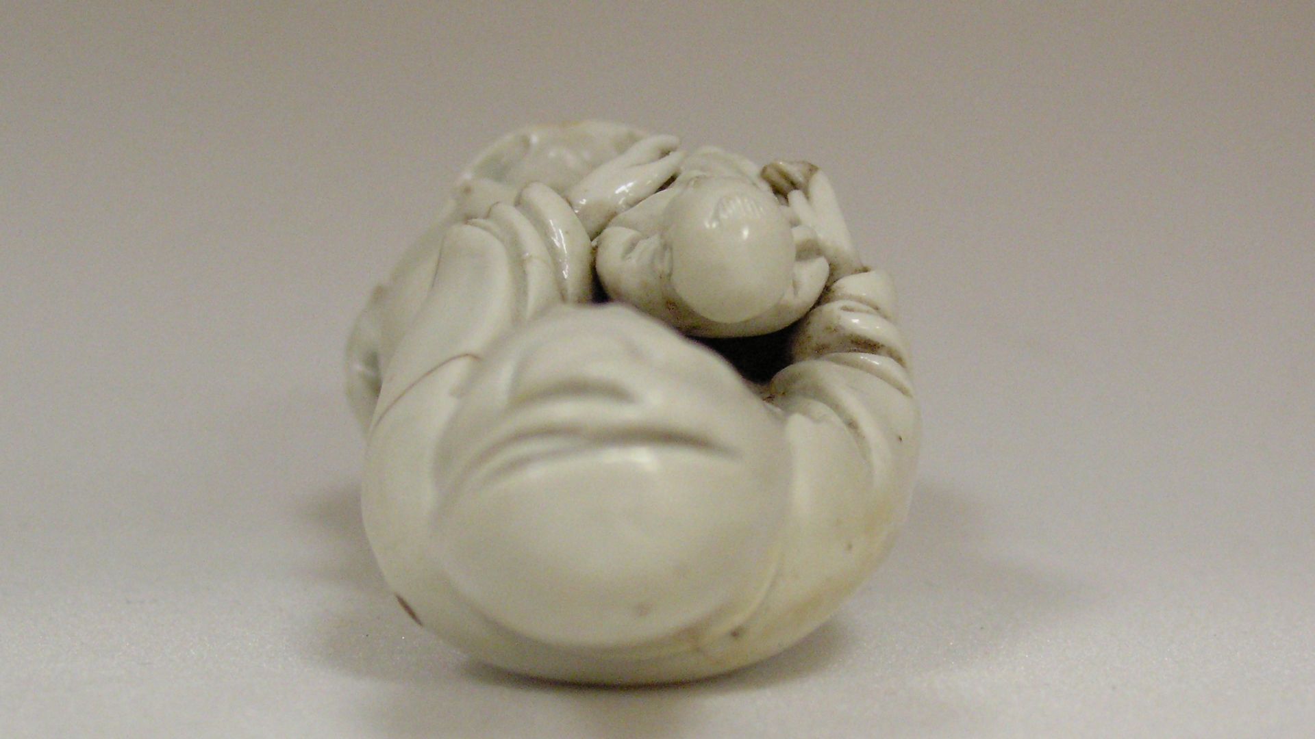 Figure, porcelain, Te Hua, blanc-de-Chine, Fukien ware. Goddess Kuan Yin and child. Such figures were influenced by the virgin and child figures made for the Spanish market. The Chinese traditionally prayed to Kuan Yin for a child.