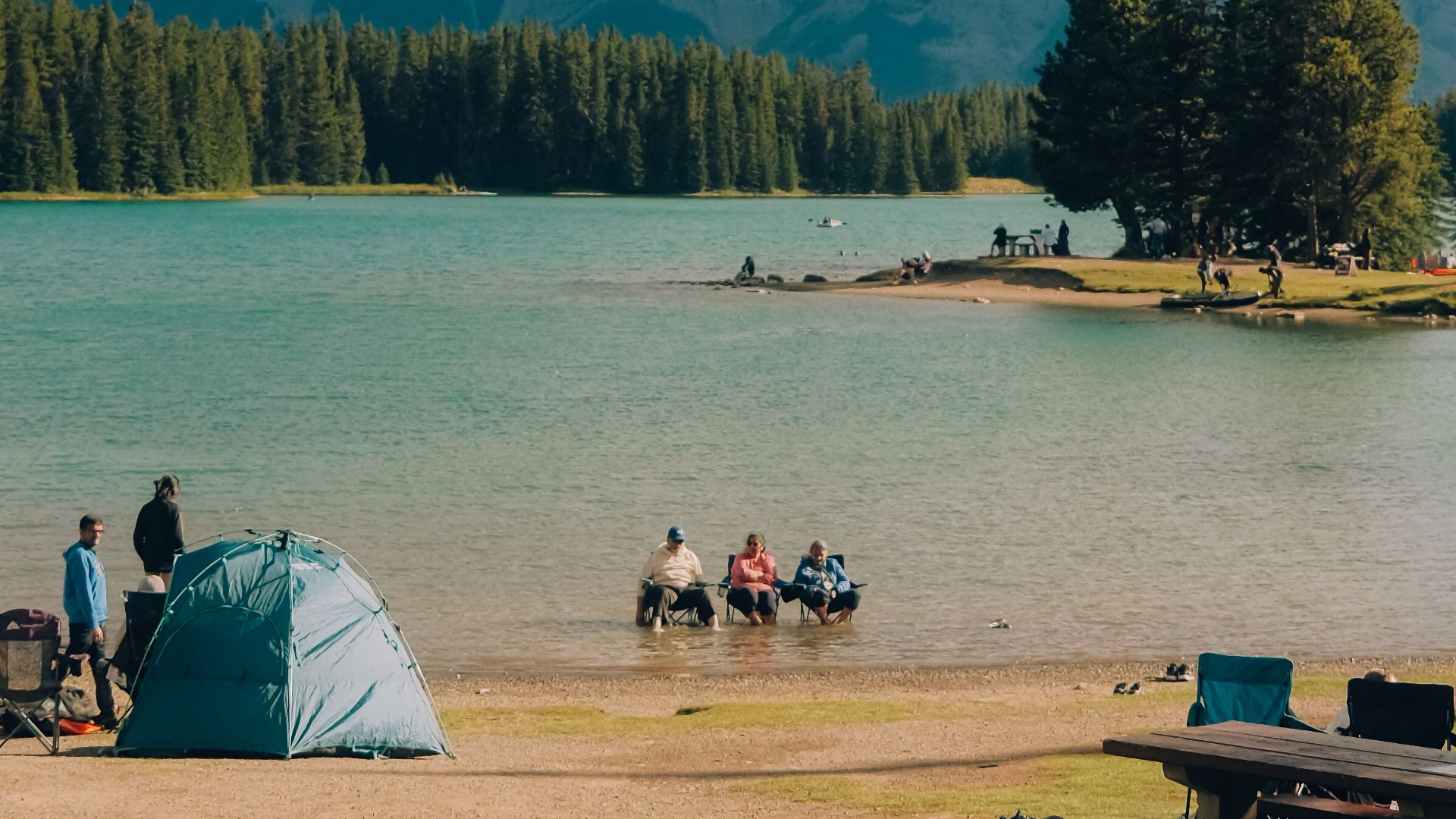 Experience the serene beauty of Banff National Park with camping by the lake and majestic mountain views.