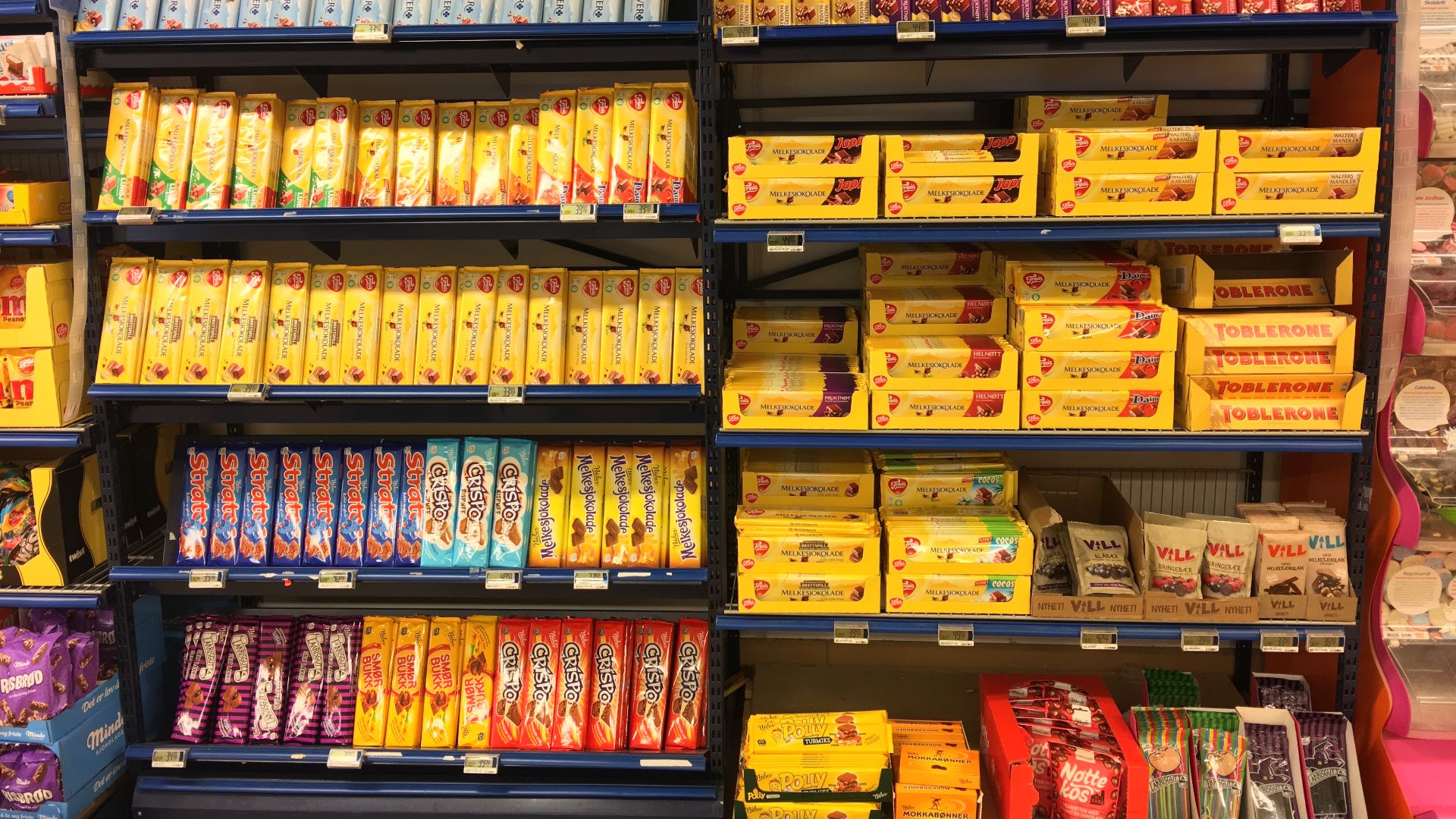 Confectionery aisle with Norwegian chocolate bars from Freia, Nidar, etc. in REMA 1000 Supermarket, Osøyro, Hordaland, Norway 2018-03-19