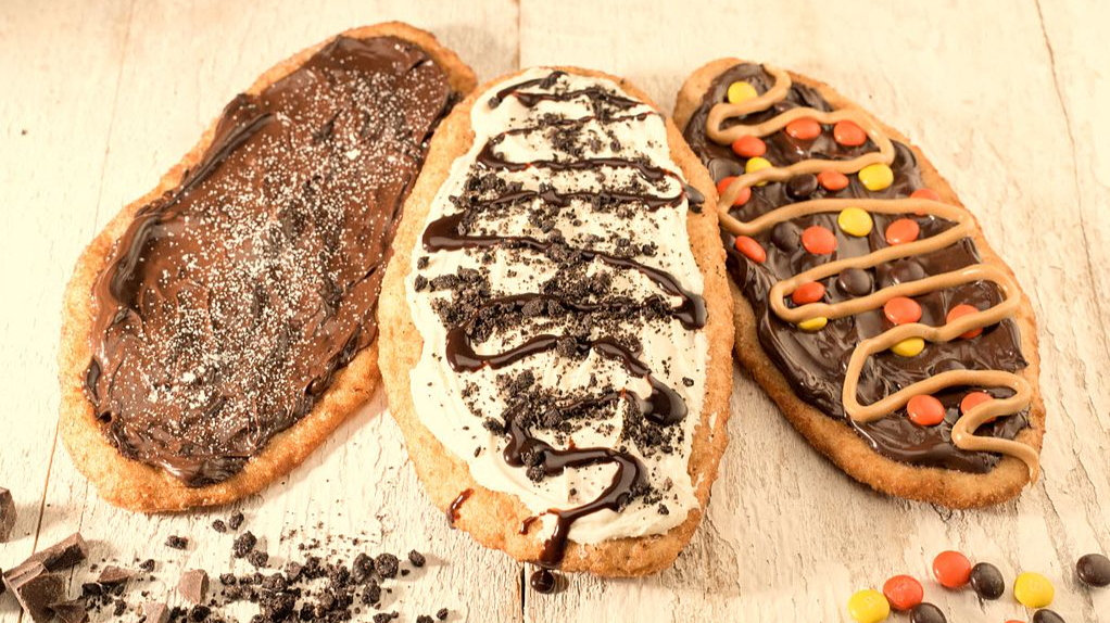 Close Up Photo of Three Beavertail pastries placed on a wooden surface