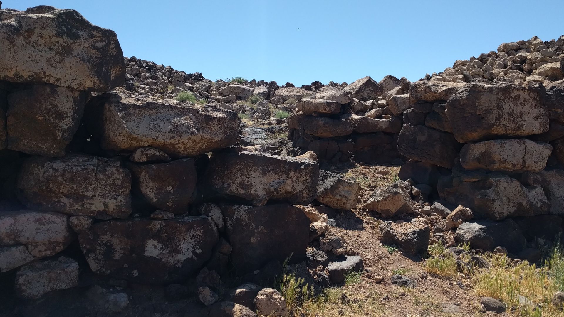 Photograph of remains of the city gate of Jawa, a Bronze Age city in the Black Desert, eastern Jordan.