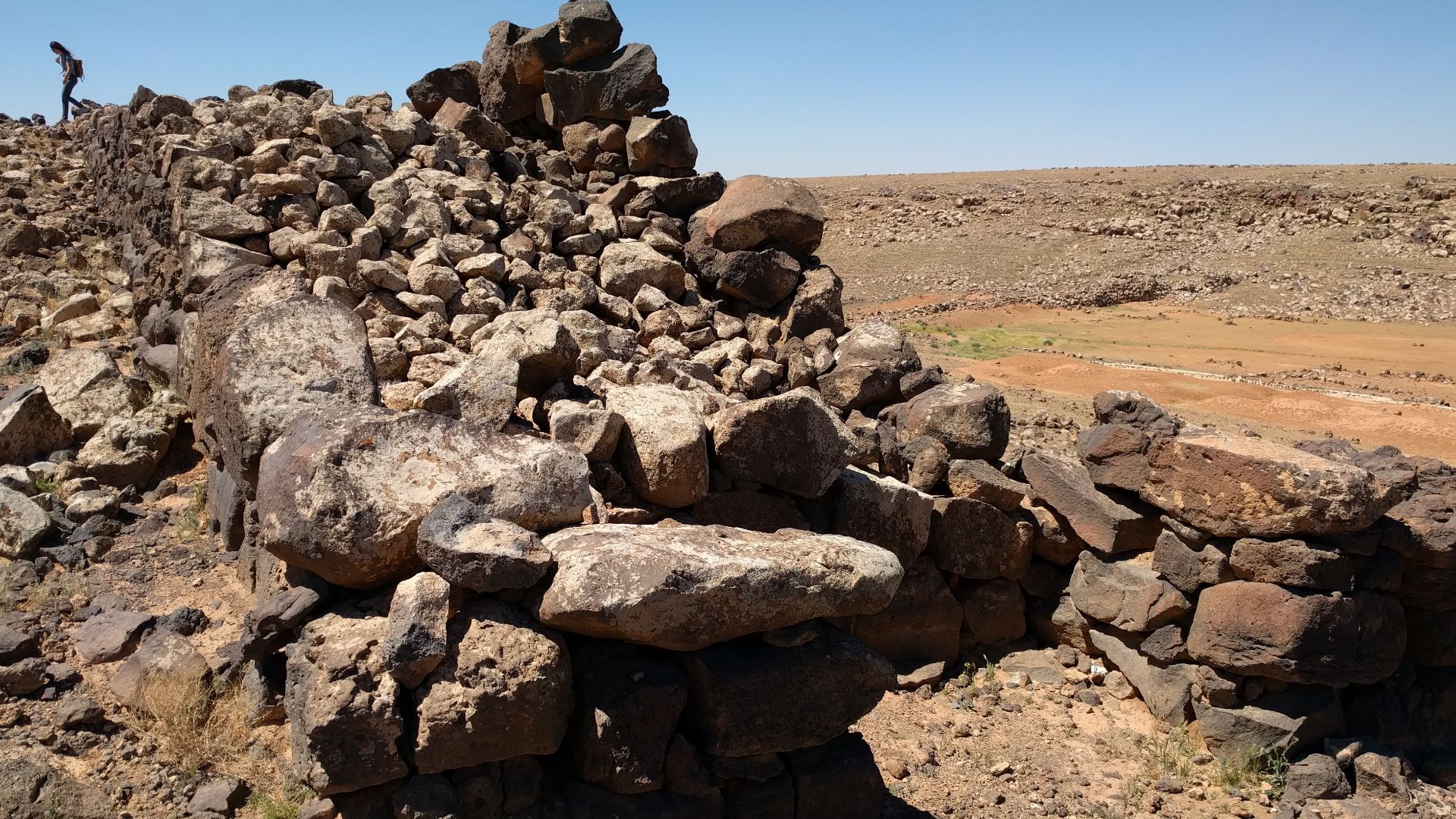 Photograph of remains of the city walls of Jawa, a Bronze Age city in the Black Desert, eastern Jordan.