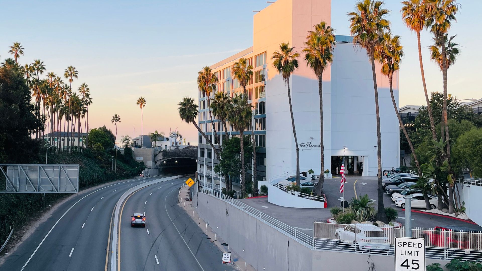 A serene highway view near Santa Monica with palm trees and a clear sky.
