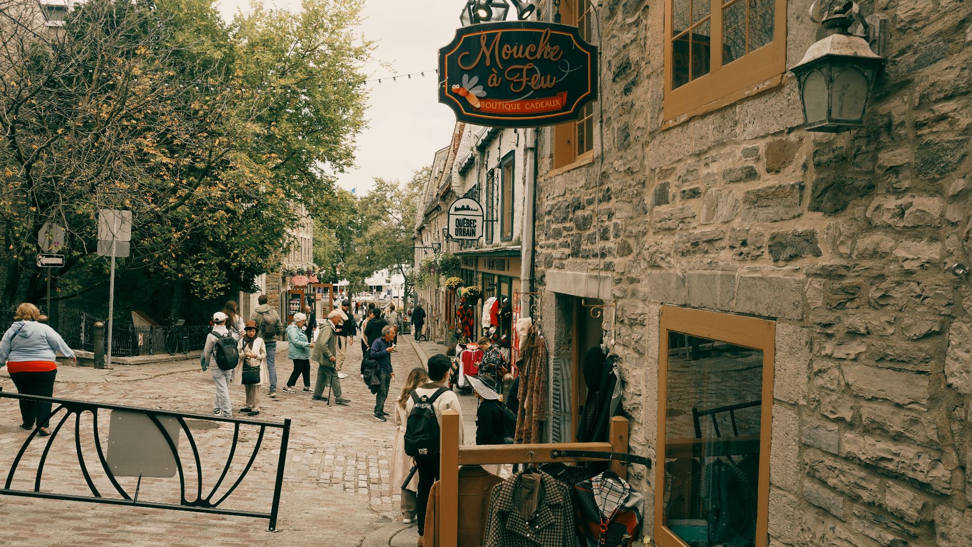 Explore a picturesque street scene in Old Quebec City, showcasing vibrant shops and historic architecture.