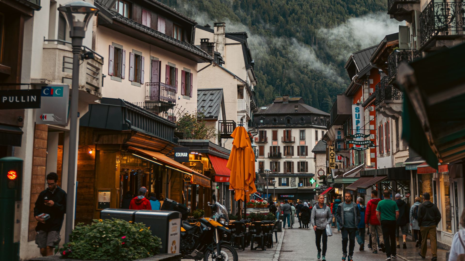 Captivating view of Chamonix town streets with the Alps in the background, showing lively atmosphere.