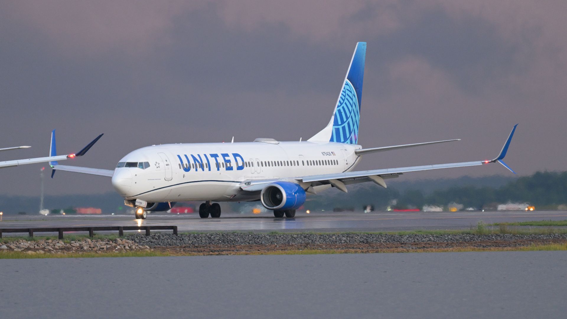 United Airlines Boeing 737-900ER N75426 taxis on taxiway N at Boston Logan International Airport.