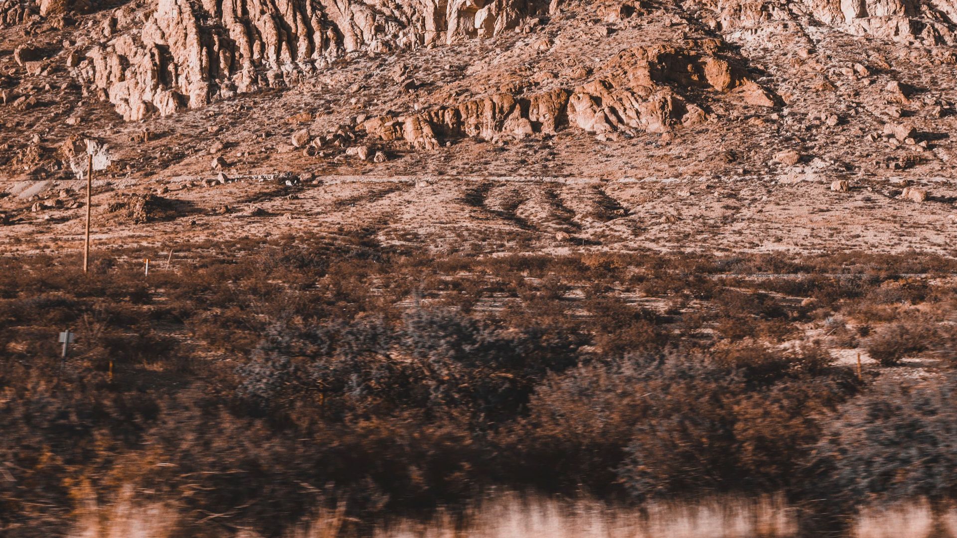 Captivating rocky desert landscape with towering cliffs under a clear sky in daylight.