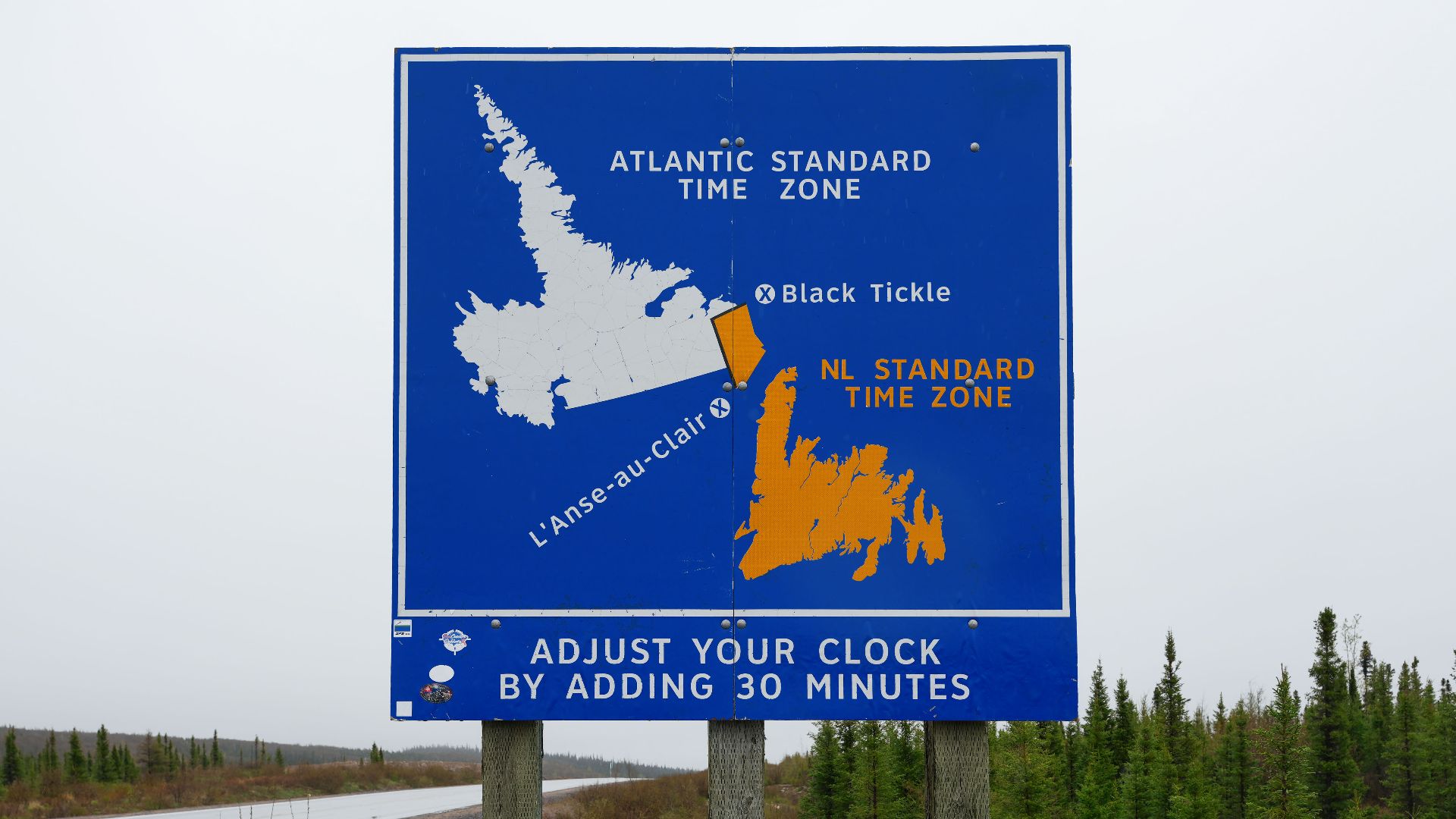 Newfoundland time-zone sign on Trans-Labrador Highway between Cartwright Junction and Port Hope Simpson, marking the change from Atlantic Time to Newfoundland Time in southeastern Labrador.