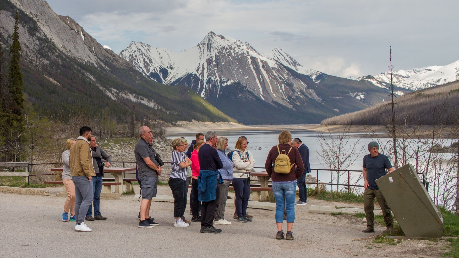 A tour guide explains to a group of tourists the purpose and importance of “Bear Proof” garbage bins in Jasper National Park. Conflict between humans and bears is a concern in Canada’s national parks. Preventing bears from feeding on garbage is a cornerst