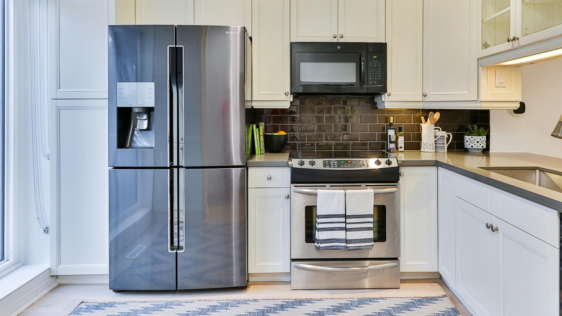 silver french door refrigerator beside white wooden kitchen cabinet