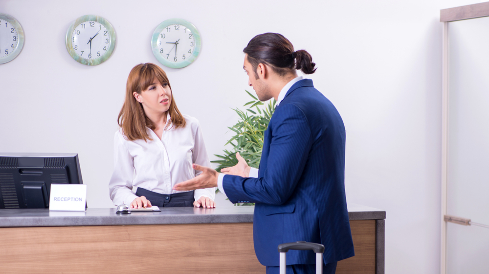 angry  businessman at hotel reception