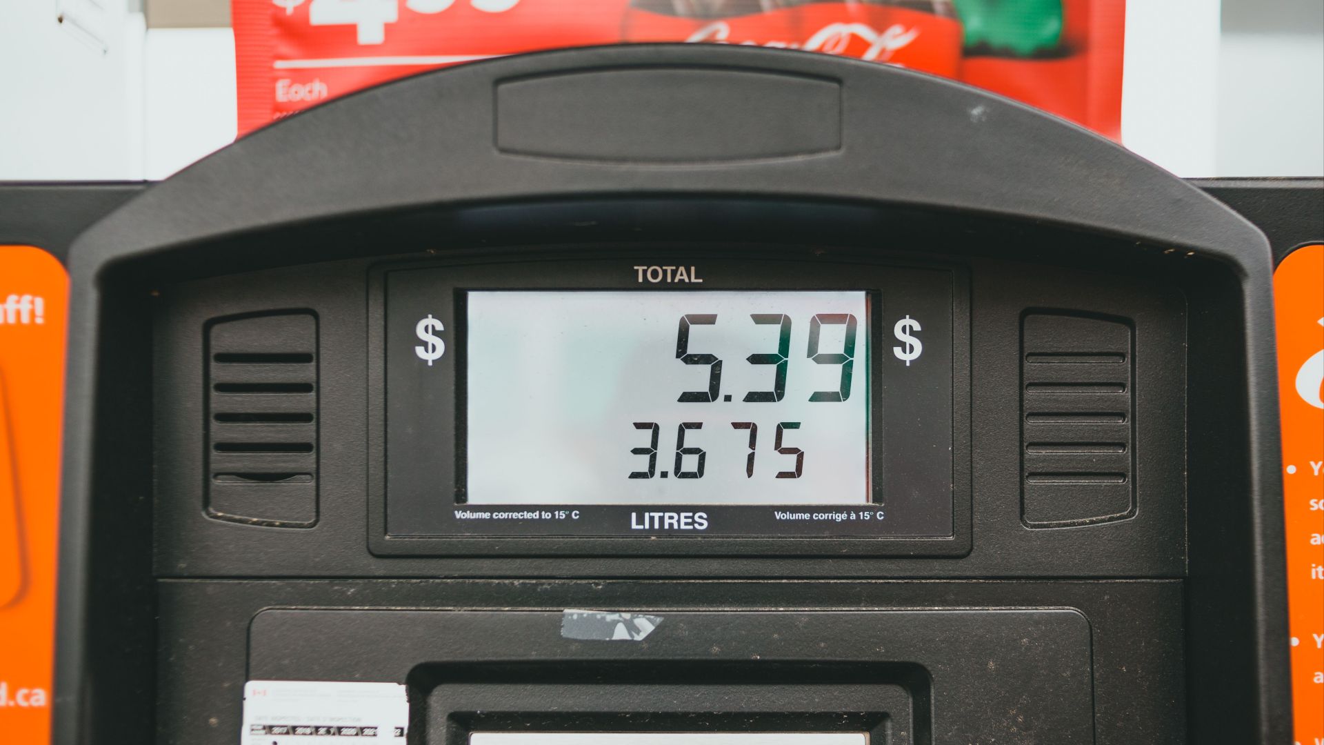 Close-up of a gas pump display showing price per liter and total volume during a transaction.