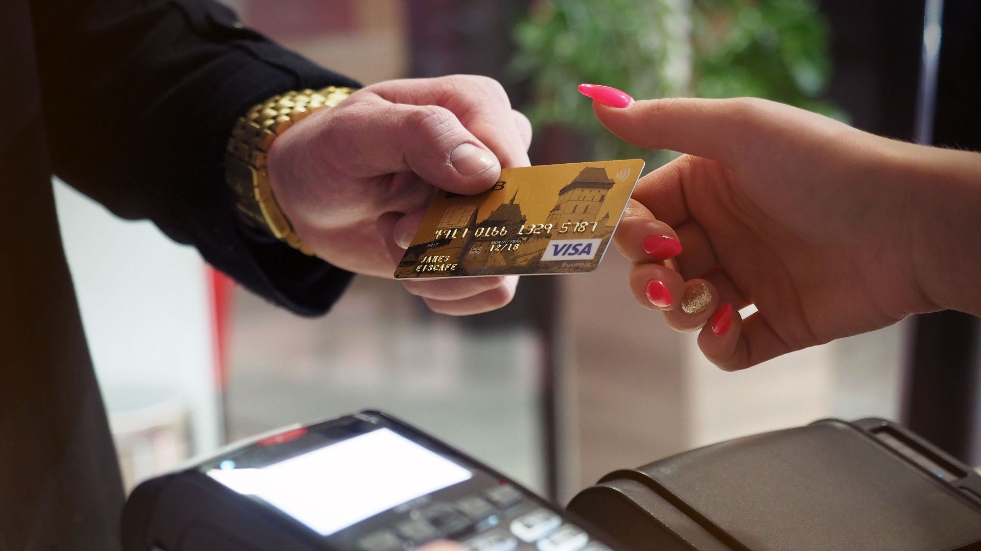 Close-up of a credit card payment being processed at a POS terminal.