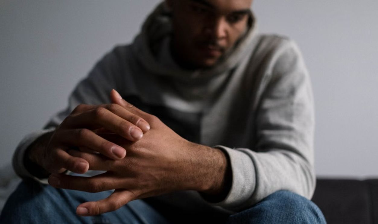 A young man sitting in solitude, expressing deep thoughts and emotions