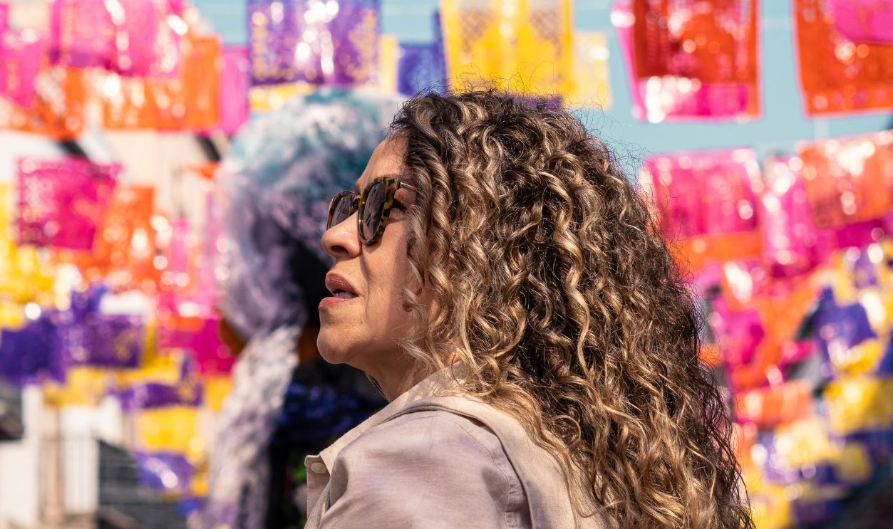 Colorful street festival scene in Queretaro with vibrant papel picado decorations and celebrating locals