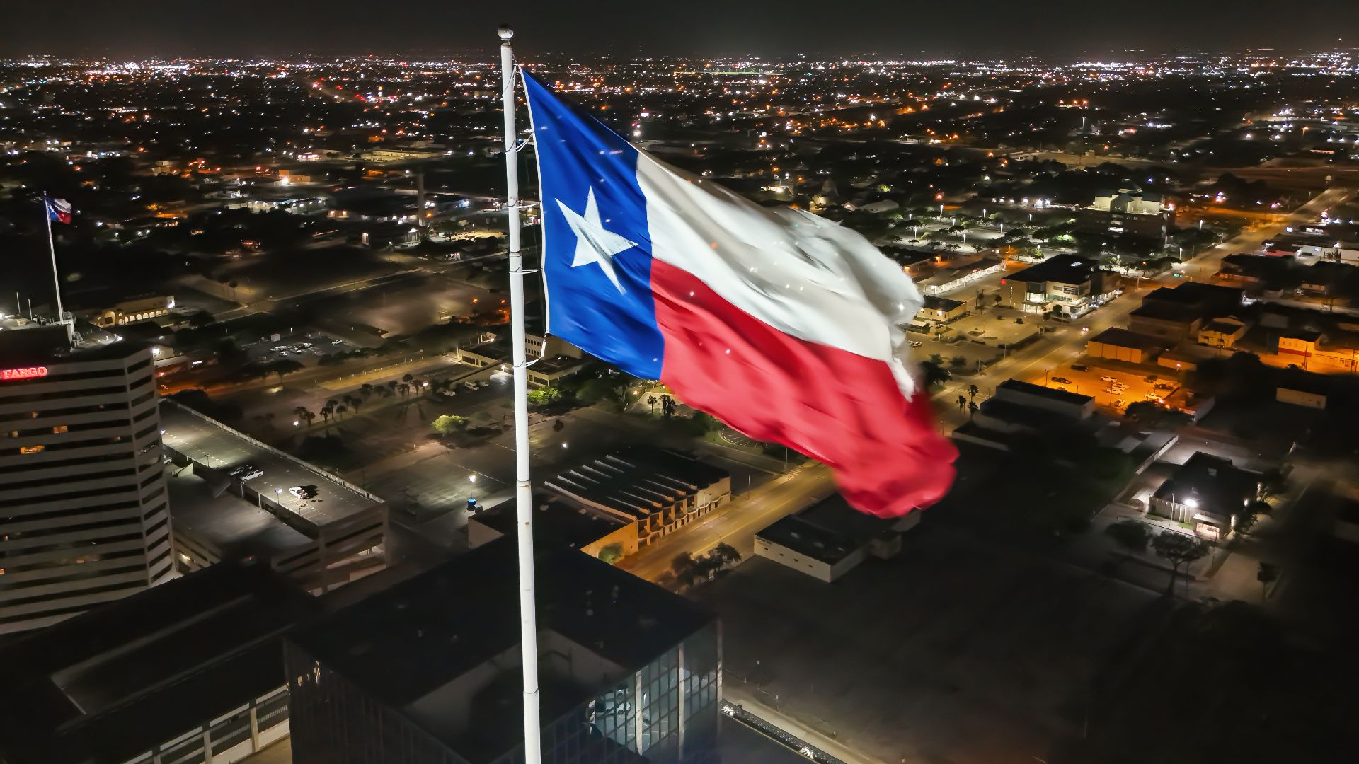 Flag of Texas waving above Corpus Christi