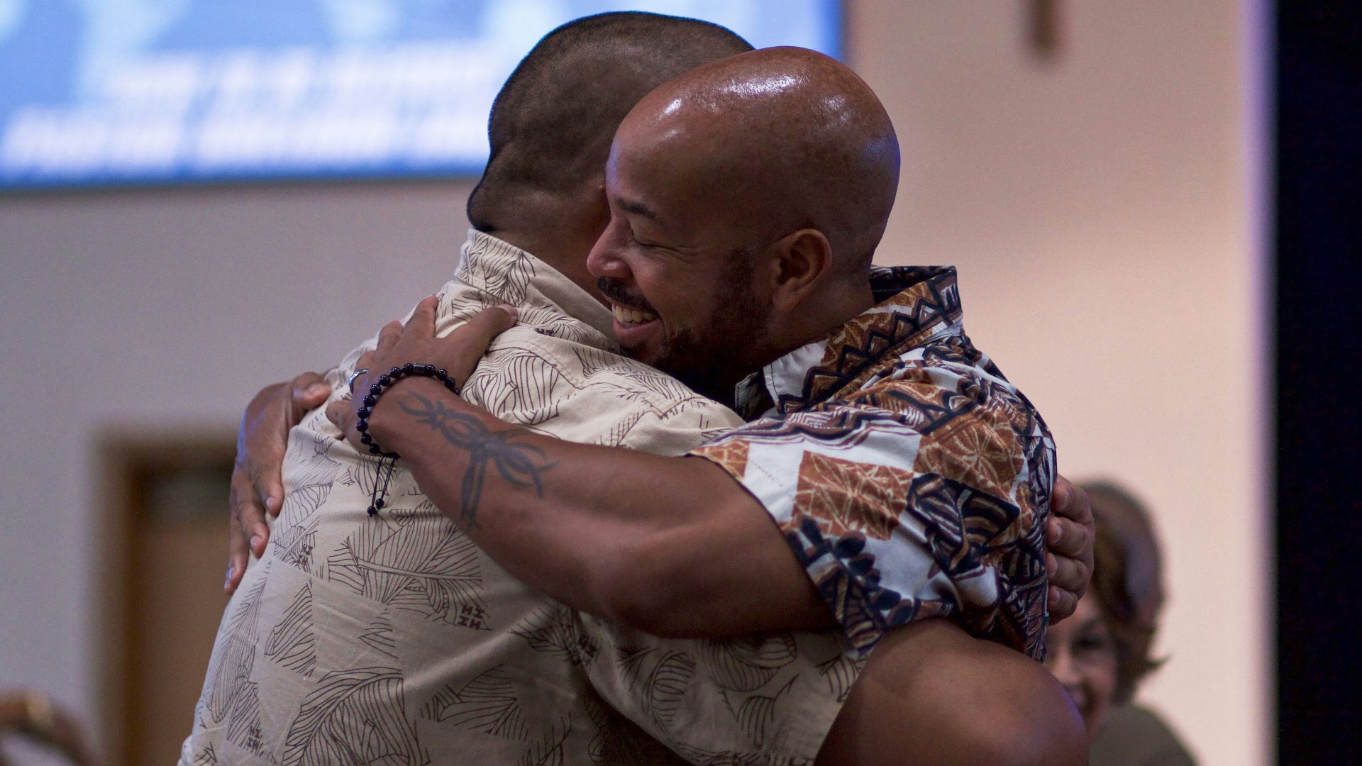 two man hugging on focus photography