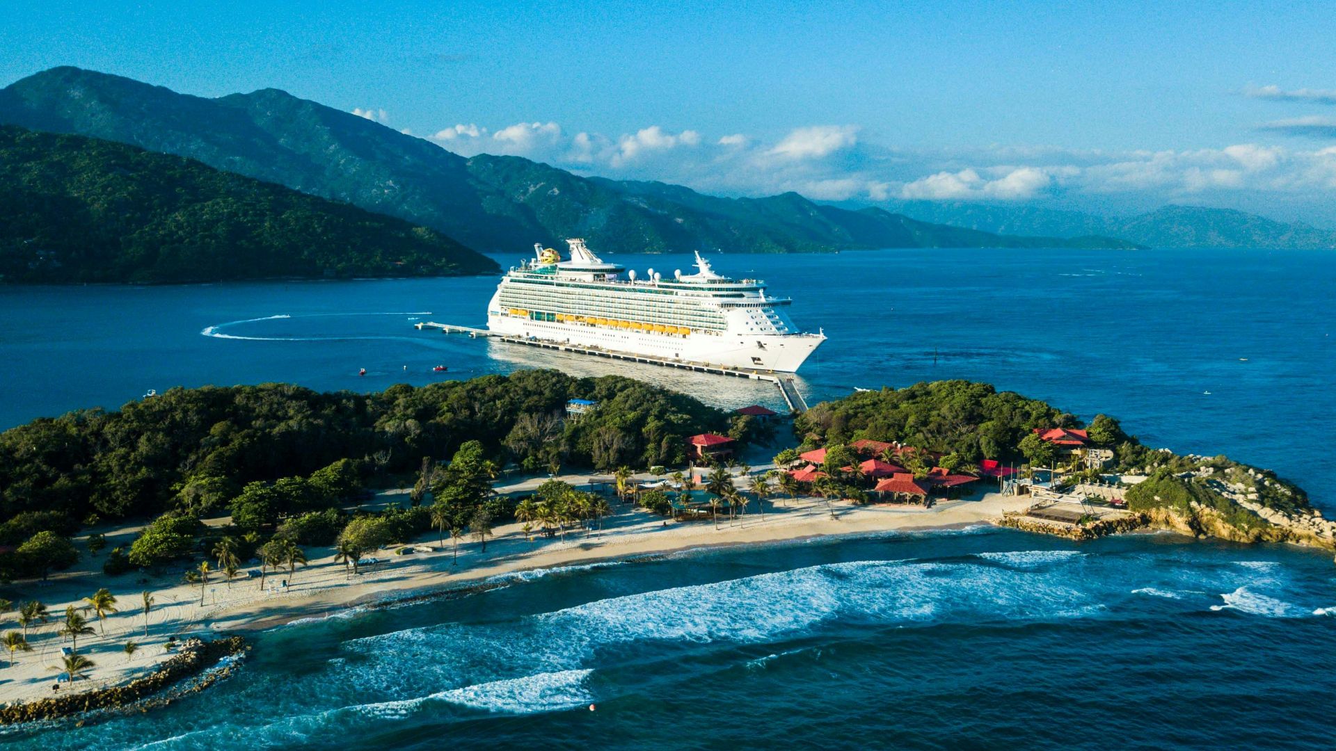 a cruise ship is docked at a small island