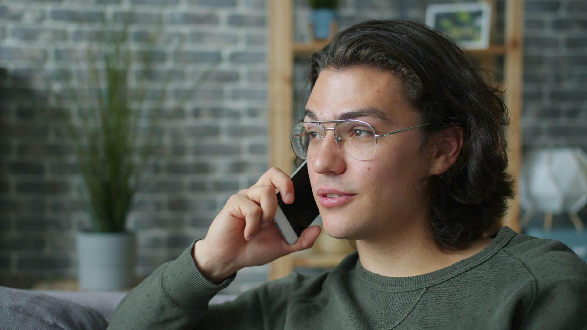 Man wearing glasses talking on a smartphone
