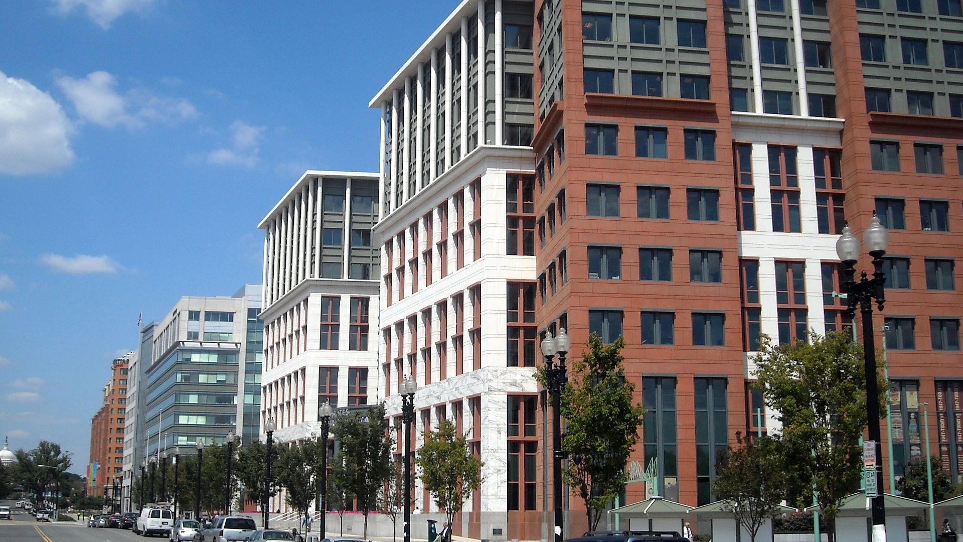 The United States Department of Transportation headquarters, located at 1200 New Jersey Avenue, S.E., in the Navy Yard neighborhood of Washington, D.C.  The dome of the United States Capitol is visible in the background.