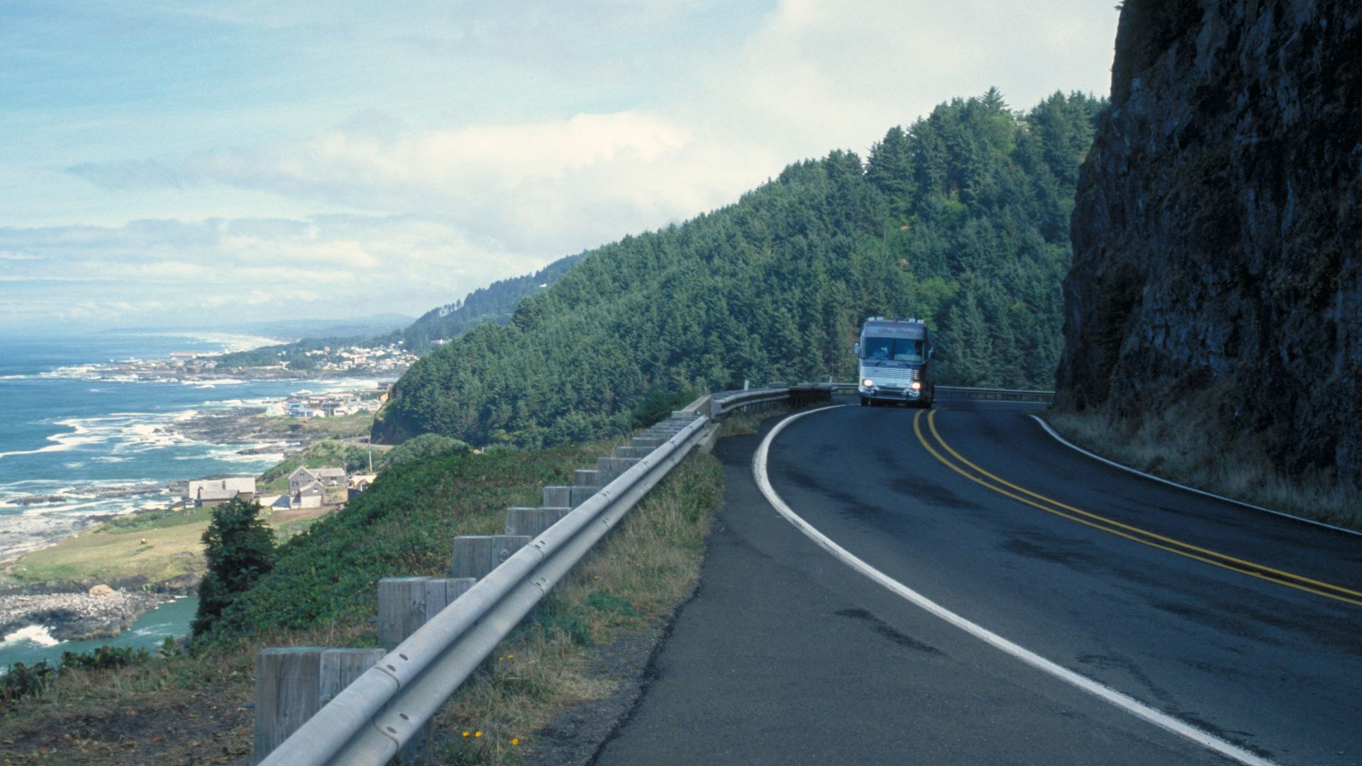 Scope and content:  The original finding aid described this photograph as:
Original Caption: A truck rounds a bend on the Pacific Coast Scenic Byway and catches an eyeful of the ocean.
Location: Oregon (44.276° N 124.113° W)

Status: Public domain. Photo 