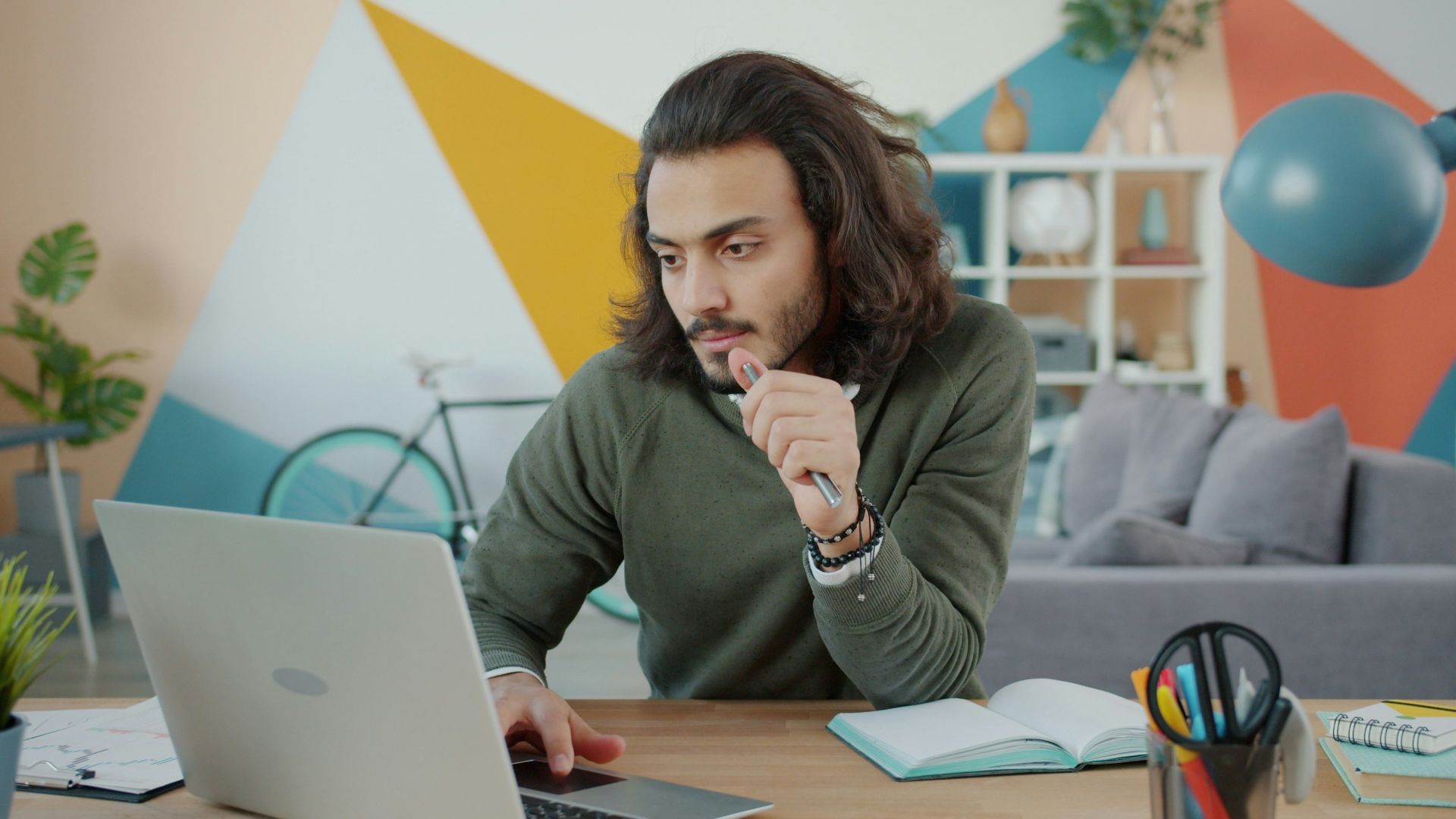Man working on laptop in colorful modern office