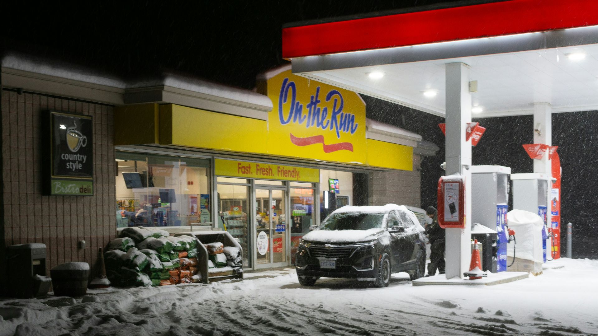 Gas station at night with snow falling