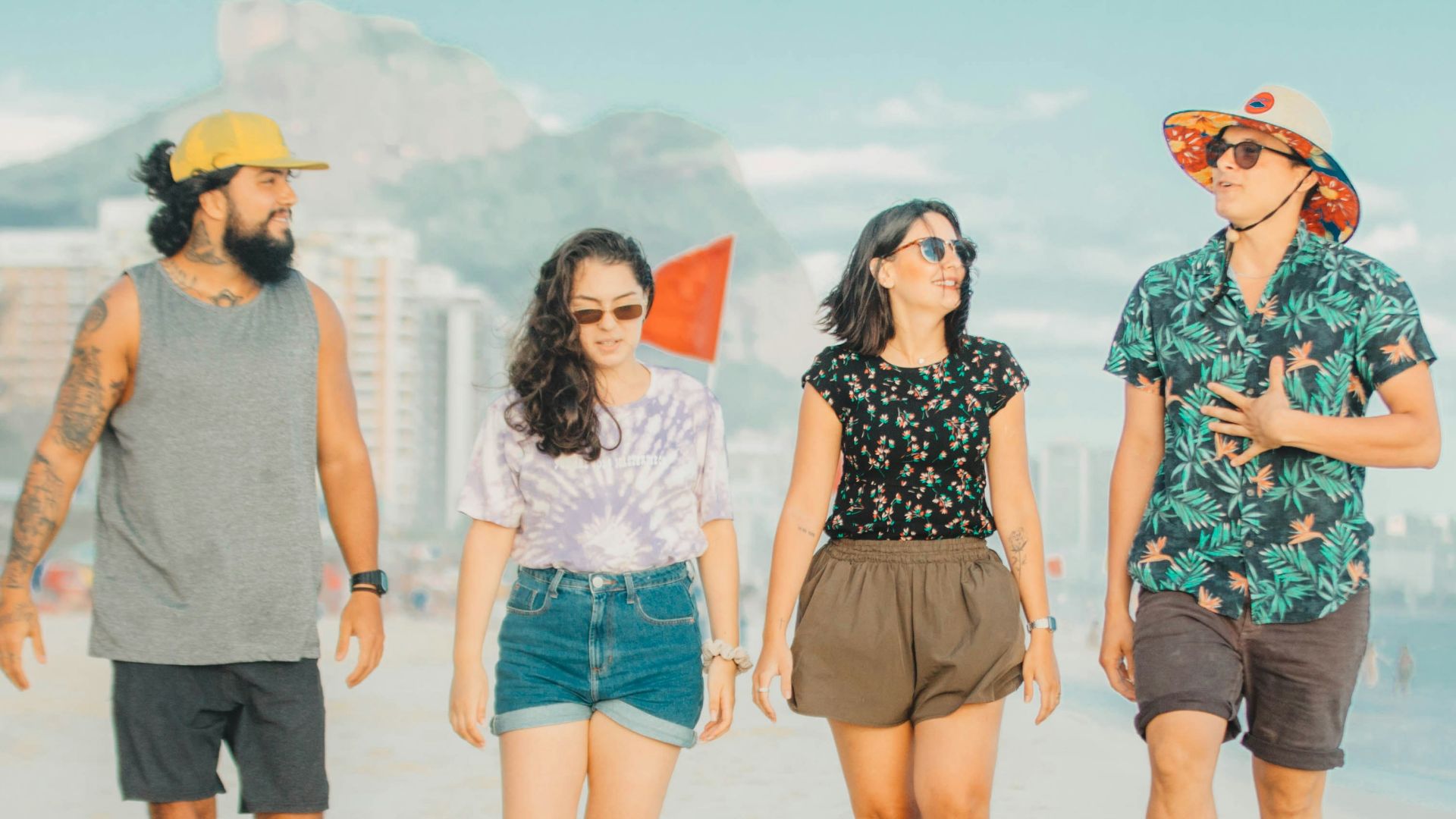 3 women standing on beach during daytime