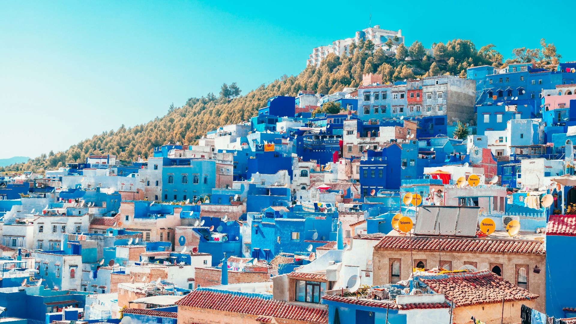 blue and white painted houses on the cliff