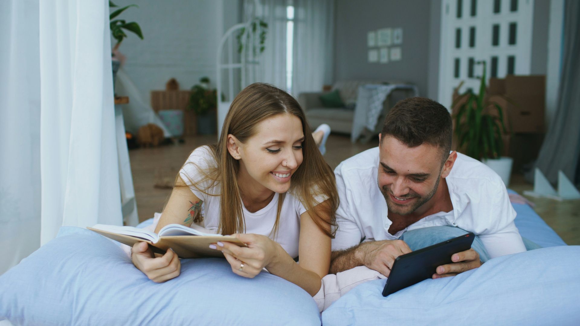 Couple lying in bed reading together