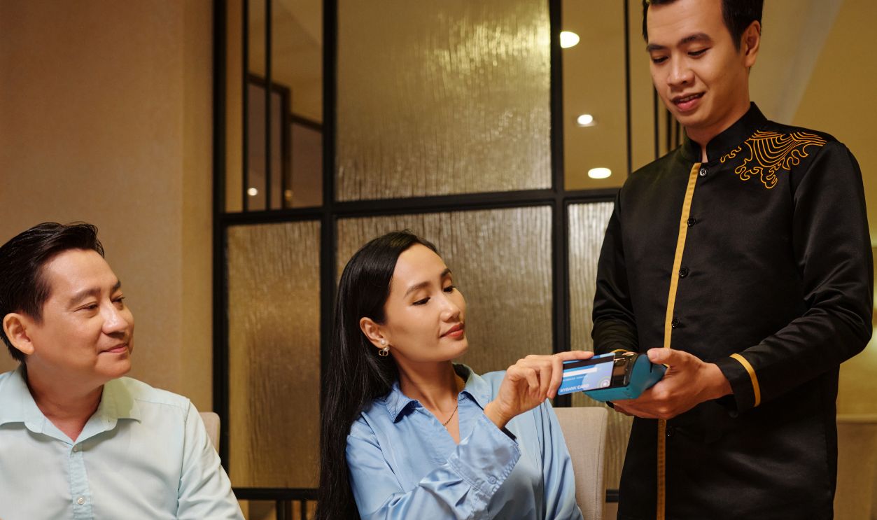 Woman Paying For Dinner In The Restaurant