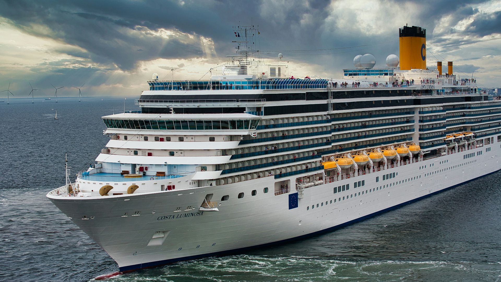 white cruise ship on sea under white clouds and blue sky during daytime