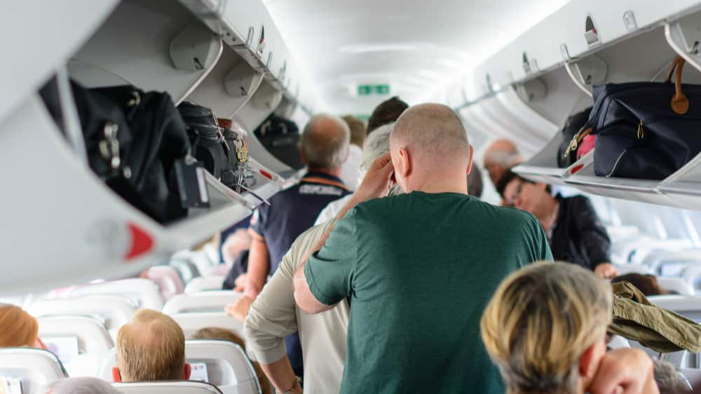 Budapest, Hungary - 25th May, 2017. People are standing and sitting in an airplane cabin before disembarking.