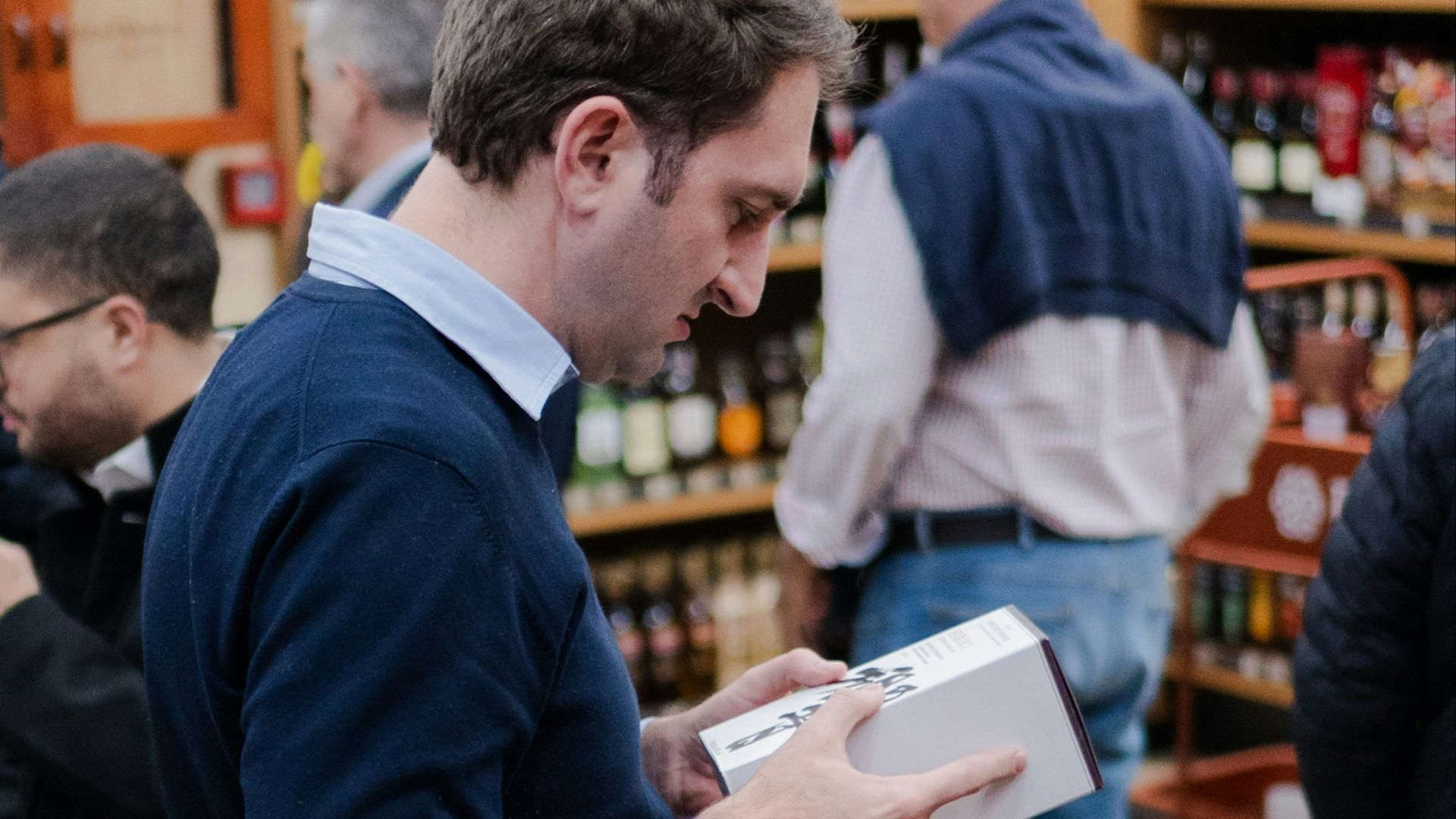 Man examining a box in a store