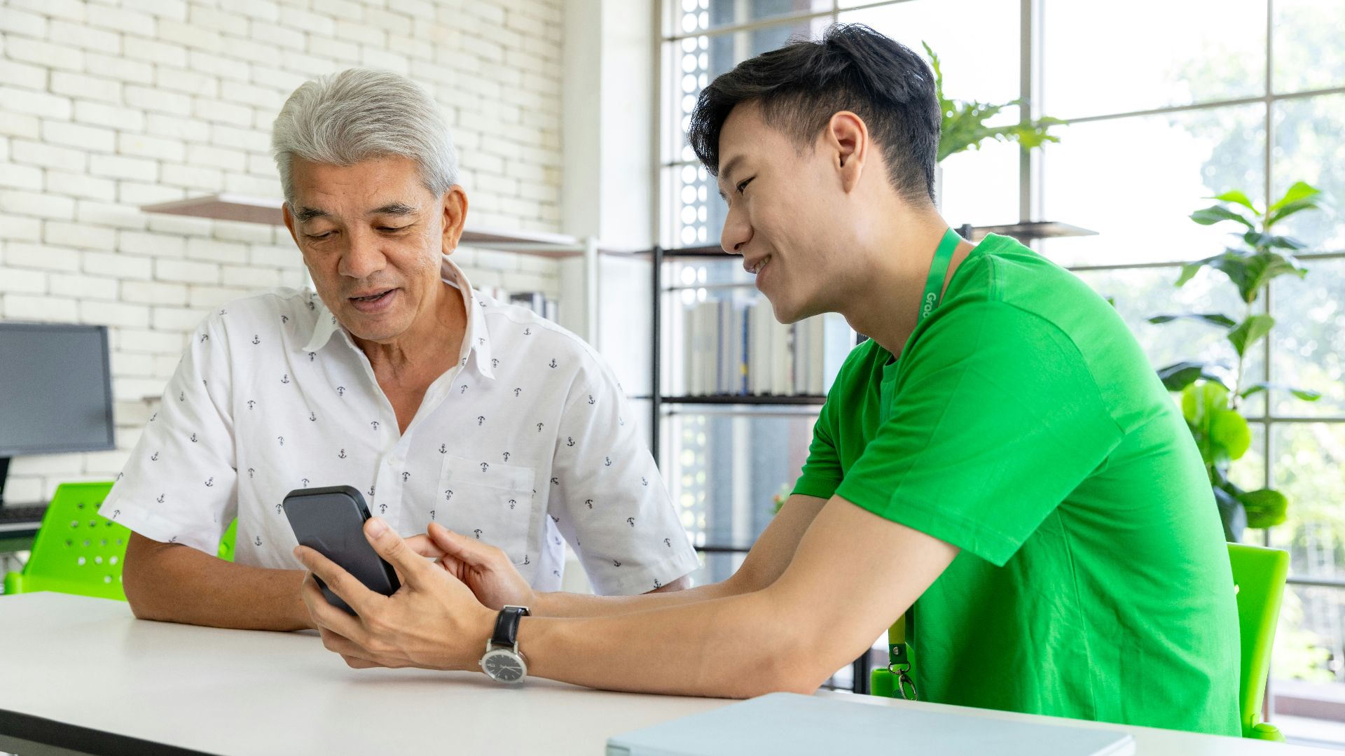 a man and a woman looking at a cell phone