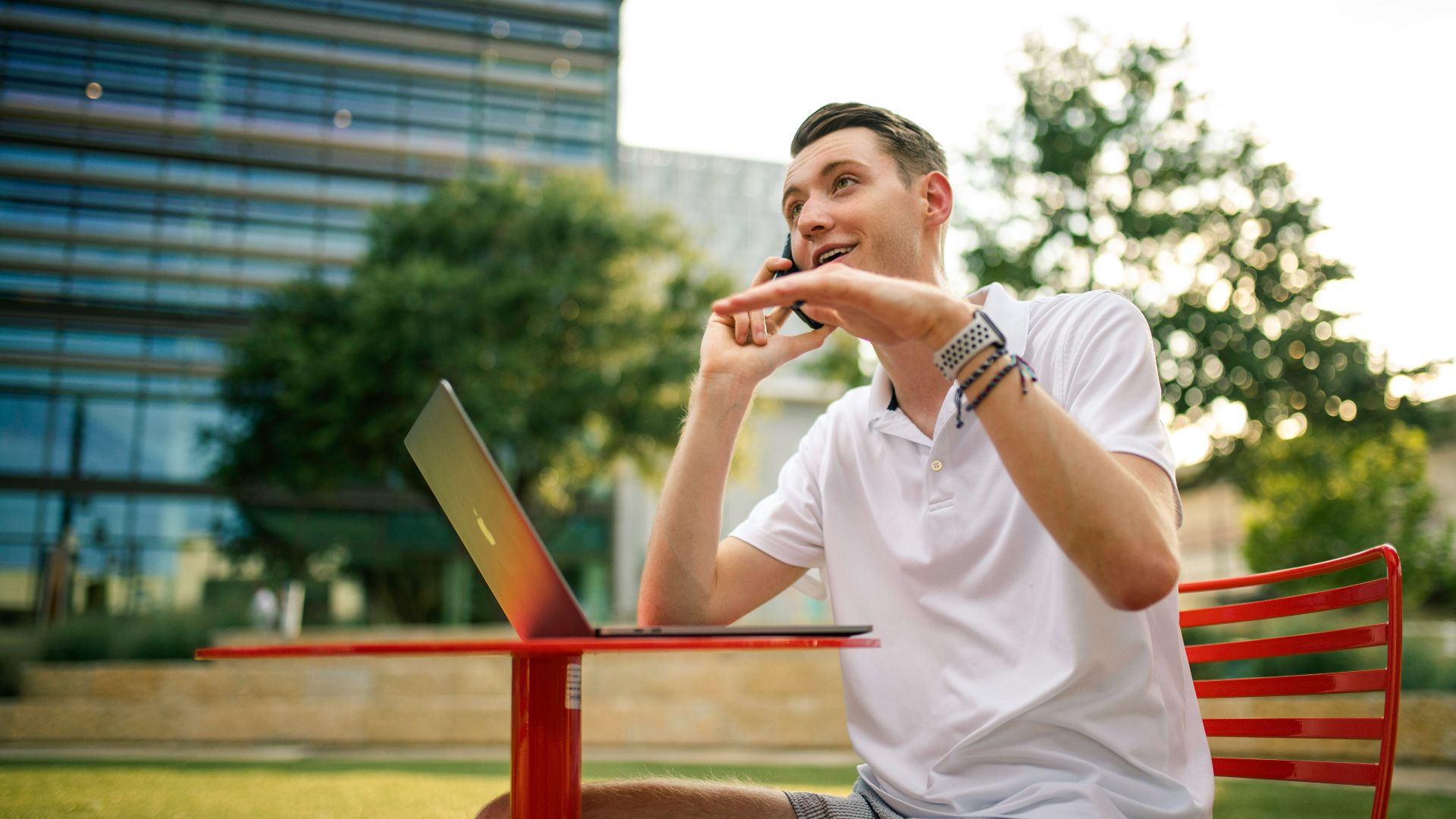 man in white crew neck t-shirt holding gray laptop computer