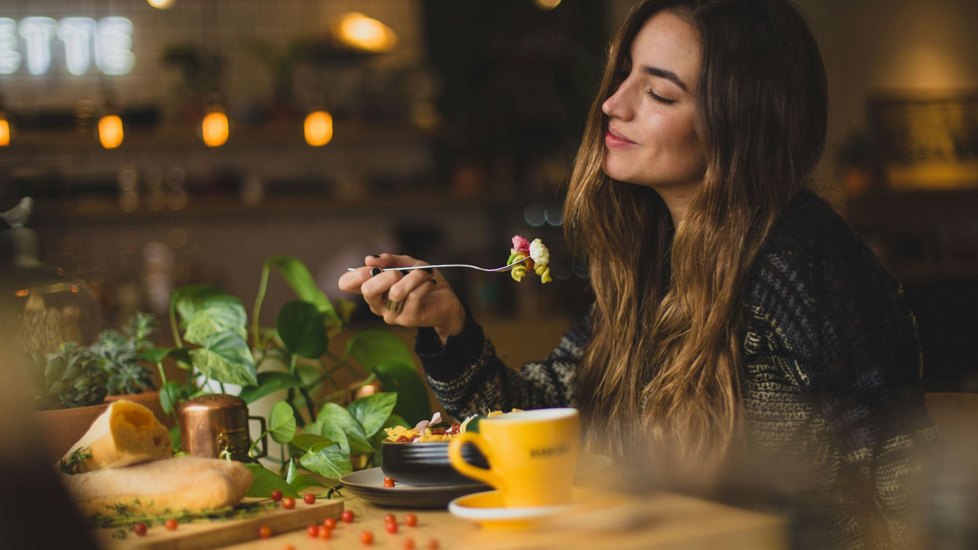 woman holding fork in front table