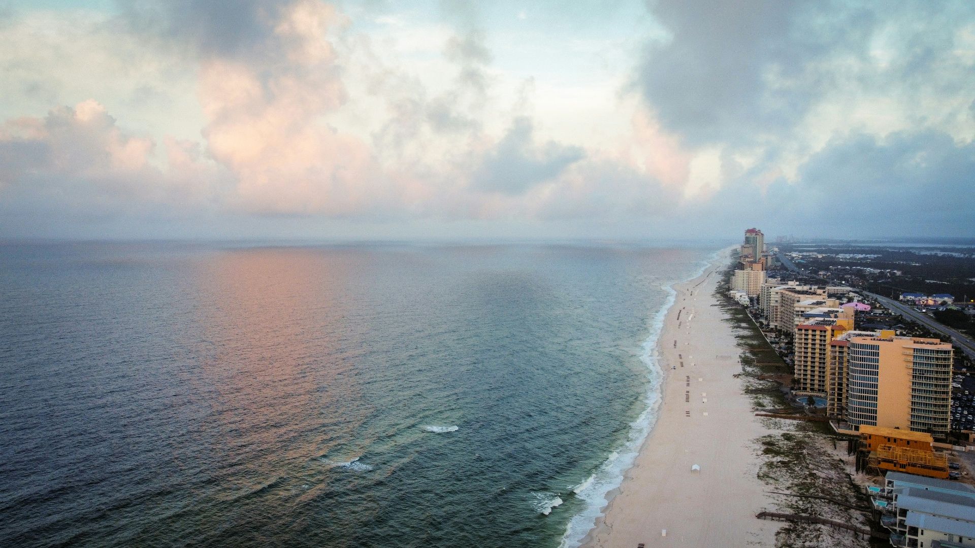 an aerial view of a beach and a city