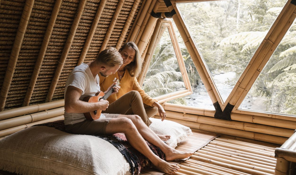 Couple enjoying music and relaxation in a bamboo house