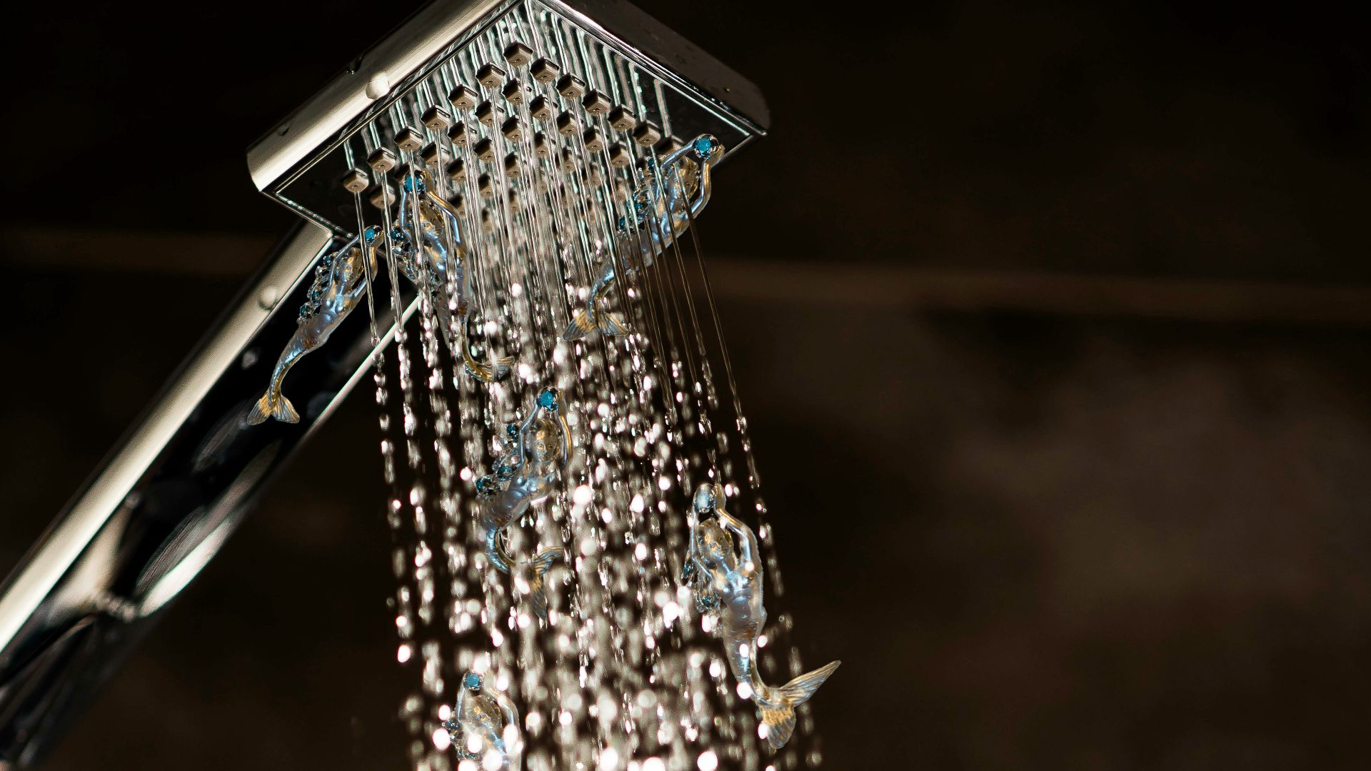 a close up of a shower head with water coming out of it