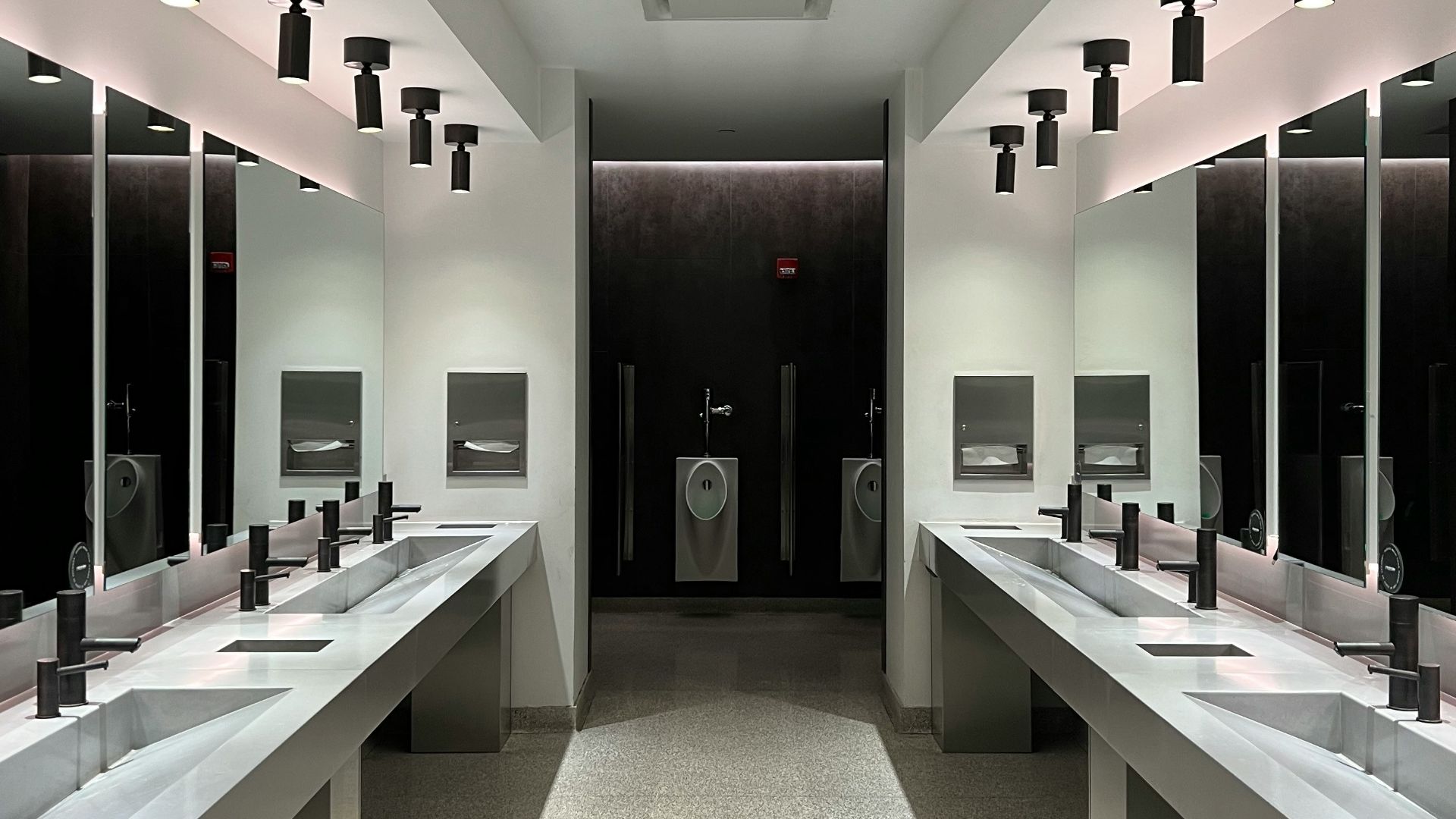a large bathroom with sinks and mirrors