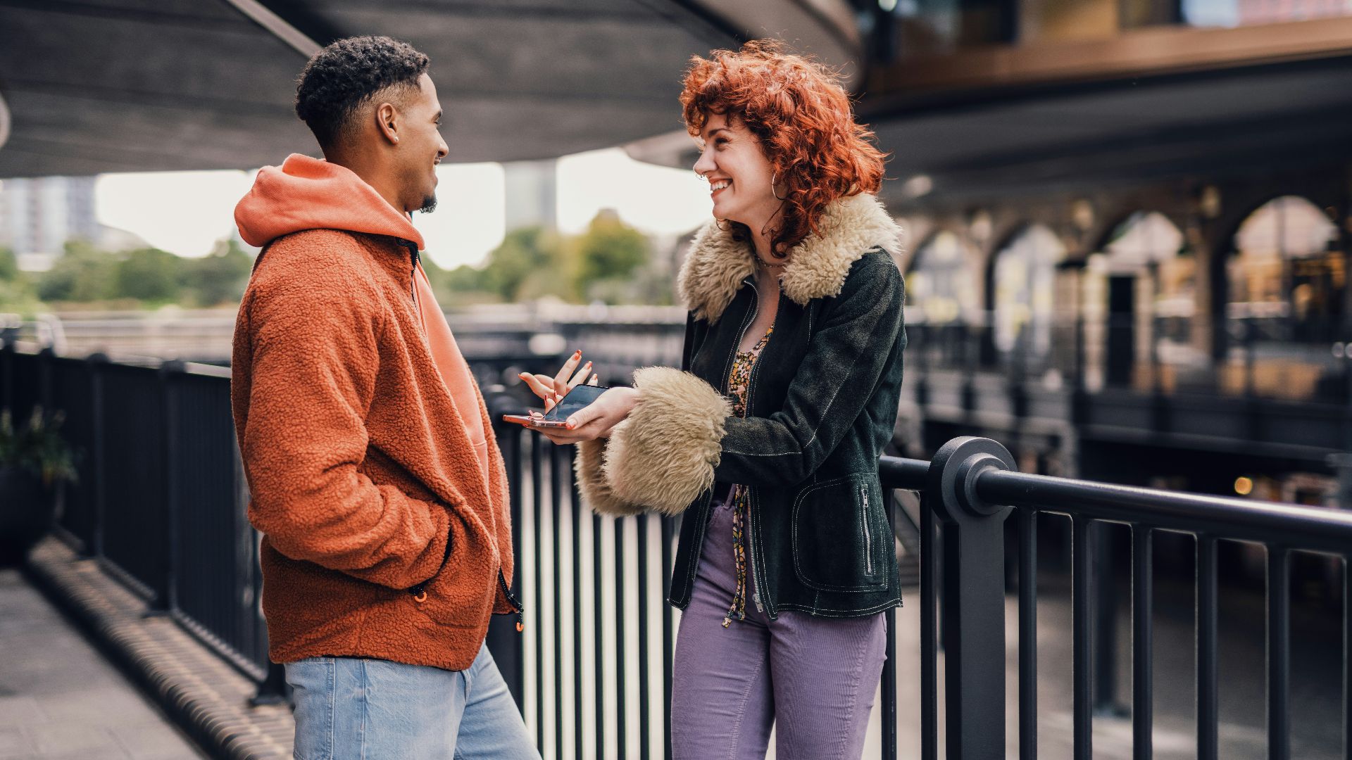a man and woman looking at a phone