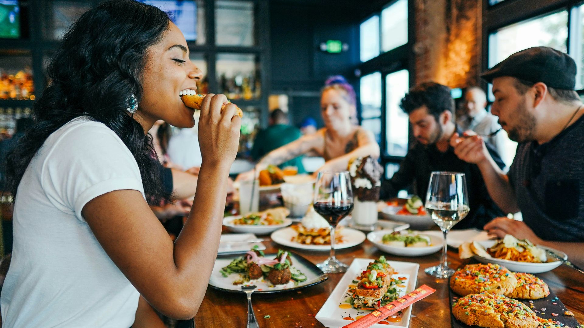 woman in white shirt eating