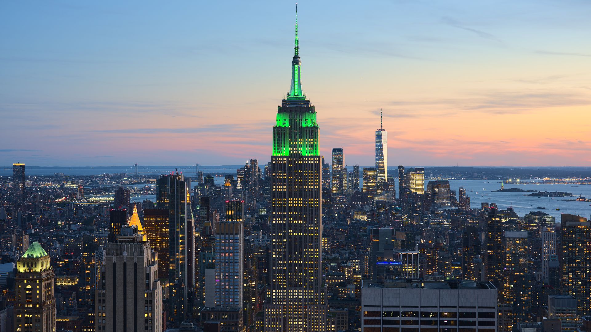 View of the Empire State Building in New York City from the Top of the Rock at 30 Rockefeller Plaza during sunset. The tower was illuminated in green in honor of Climate Week NYC.[1]