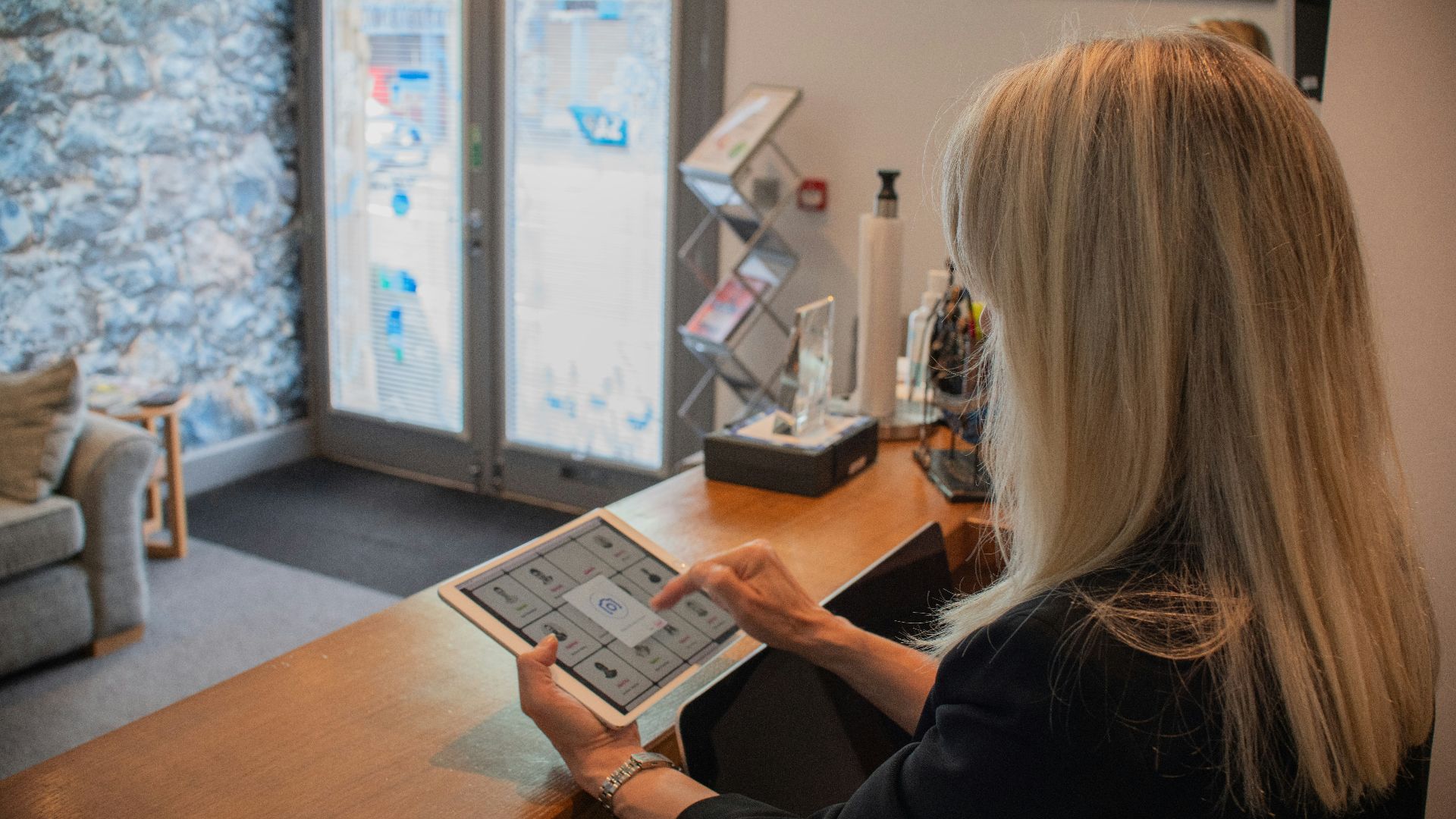 Woman using a tablet at a reception desk