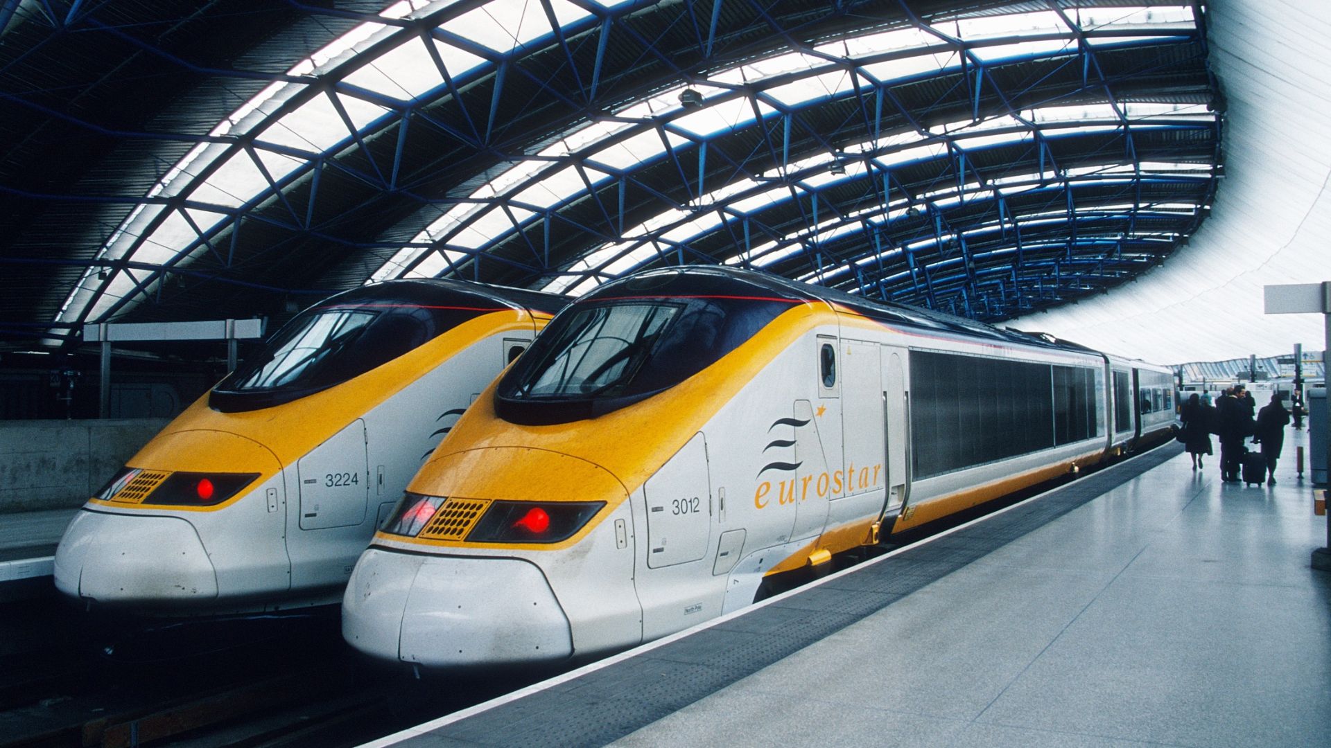 Two class 373 Eurostar units under the roof of Waterloo international station in London.