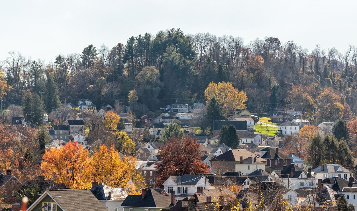 Clarksburg, West Virginia small rural town in countryside, homes, houses buildings in Appalachian mountains, rolling hills landscape in autumn fall