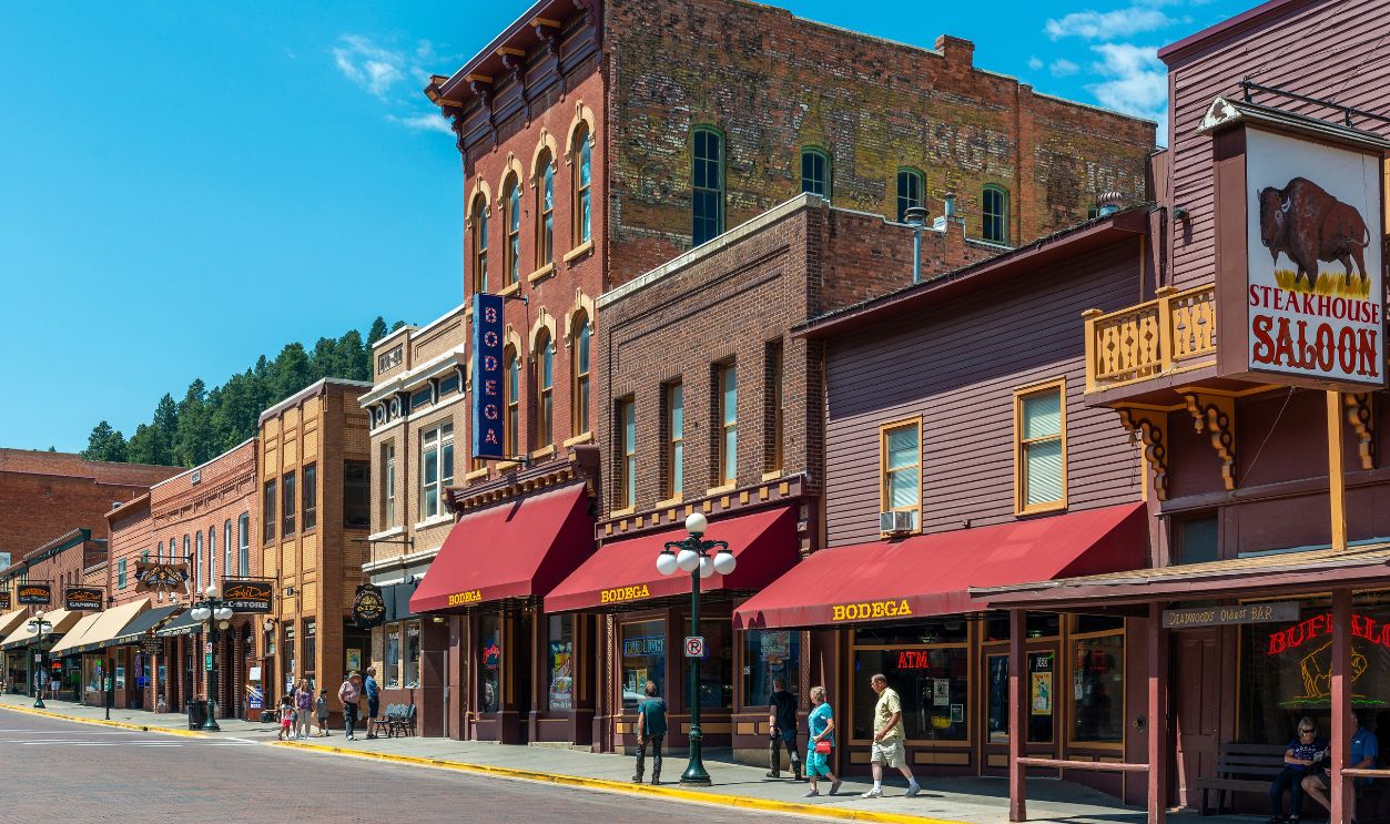 DEADWOOD, USA - JULY 18, 2017: Main street of Wild West town of Deadwood with restaurants, bars and people walking in summer, South Dakota.