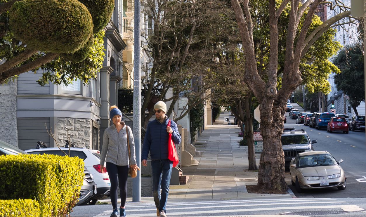 San Francisco, United States - February 14 2020 : two people are walking and chatting on the sidewalk of a typical san francisco street